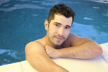 Natural looking young man in swimming pool