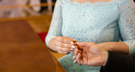 Obraz na płótnie Canvas the bride puts a wedding ring on the groom's hand. wedding.