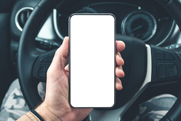 Smartphone mockup in male driver hand over car steering wheel