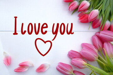 Pink tulips decoration and heart on white background. Valentine's Day card.