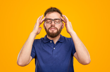 Man with headache touching temples