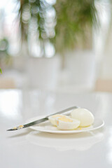 Boiled eggs on a kitchen table, healthy breakfast and protein rich diet. Eggs on a plate with a...
