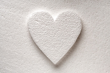 Fototapeta premium White styrfoam heart on a white styrfoam background. Valentine's day background.