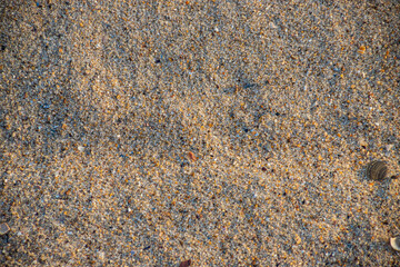 Sand on the beach for background. Brown beach sand texture as background.