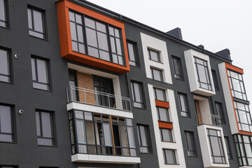 Fototapeta premium Fragment of Modern residential apartment with flat buildings exterior. Detail of New luxury house and home complex. Part of City Real estate property and condo architecture. Copy space