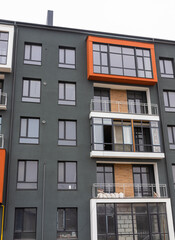 Obraz premium Fragment of Modern residential apartment with flat buildings exterior. Detail of New luxury house and home complex. Part of City Real estate property and condo architecture. Copy space