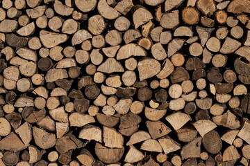 Pile of stacked triangle firewood prepared for fireplace and boiler