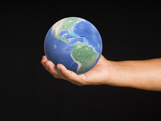 Senior man holding the Earth in his hand. Concept of saving the Earth, environment, and energy.