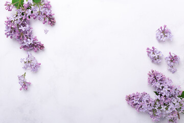 Flowers composition. Frame made of lilac flowers on stone background. Mothers day, womens day concept. Flat lay, top view - Powered by Adobe