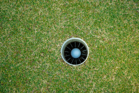a golf ball in to the hole