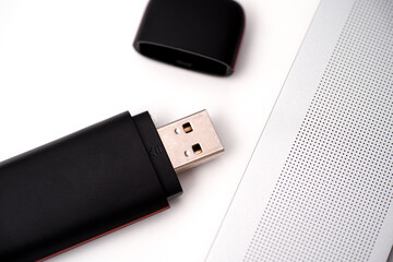 Black USB Flash Drive near a laptop on a table
