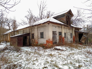 Old abandoned ruined wooden house in the countryside