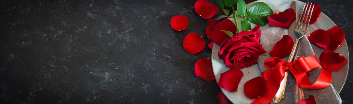 Red table decoration for valentines day
Romantic red table decoration on black table for a valentine's day dinner. Horizontal background concept with short depth of field and space for text. Top view.