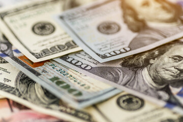 Money american hundred dollar bills.Closeup of assorted American banknotes.US currency scattered on the table.america currency dollor currency.World economic crisis associated with coronovirus.