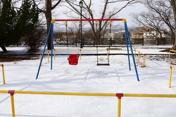 Play set with snow in the winter park.