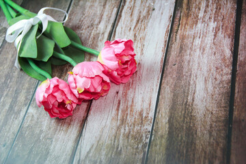 pink tulips on wooden background