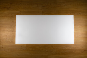 White sheet of paper on wooden background