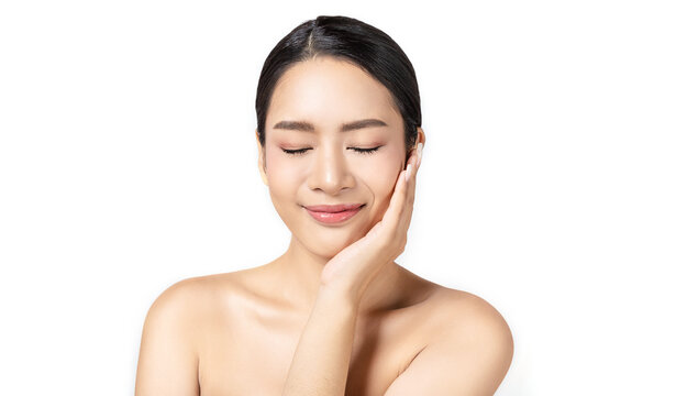 Closeup portrait of beauty asian woman with fair perfect healthy glow skin hand touch cheek eyes close isolated white, young beautiful asia girl with pretty smile on face. Beauty korean spa skincare.