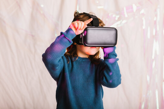 Girl exploring cyberspace in VR glasses