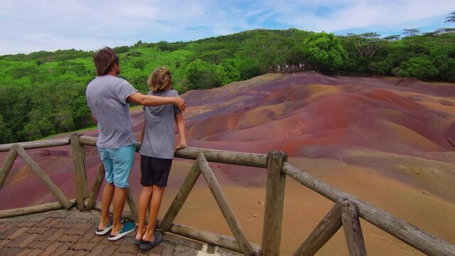 The family admires the famous place. Seven coloured earths. A formation in nature that has become a huge tourist attraction on island Mauritius