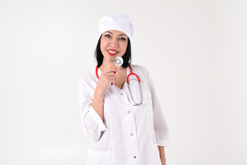 A female therapist with a stethoscope in the clinic on a white background