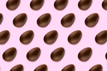 Chocolate easter eggs on pink background lined up as a pattern
