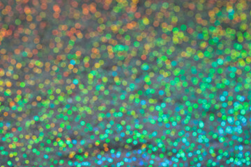 Abstract blurred background of holographic rainbow fabric