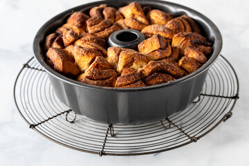A homemade apple cinnamon pull apart bread in a bundt pan, fresh out of the oven
