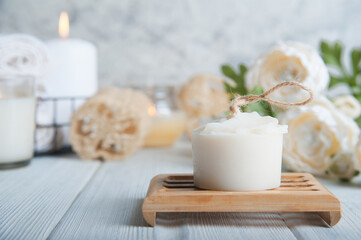 Natural soap, loofah scrubber on podium in bathroom. Zero waste in life. Relaxation spa concept, candles, beauty...