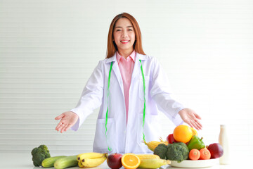 Asian female doctor or nutritionist Consulting the patient about the diet There were various fruits...