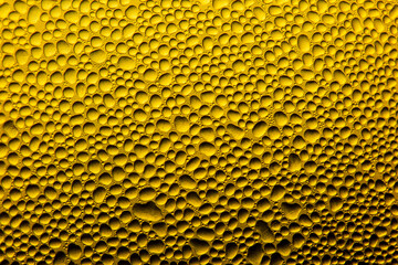 Water drops on yellow. Water drops light abstract background. Beautiful fresh morning dew.Spring. Summer. Morning.