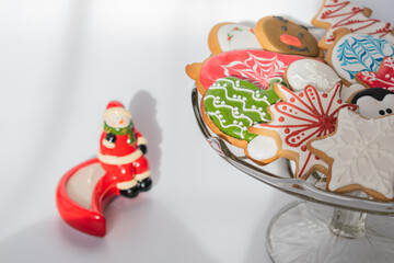 Traditionally decorated handamde Christmas gingerbread cookies served on a glass bowl