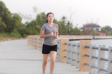 Asian woman runners she was running on the road in the morning