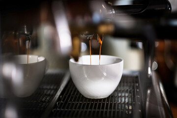 Coffee is prepared in a coffee machine in a cafe. Close-up