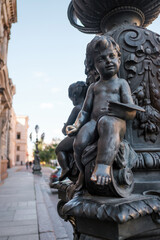 Architectural elements. Vintage street lamp near Stieglitz State Academy. Close-up sculpture of a little angel.