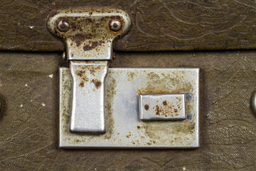 Close-up of an antique suitcase clasp.