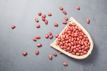 red peanuts in a bamboo dustpan