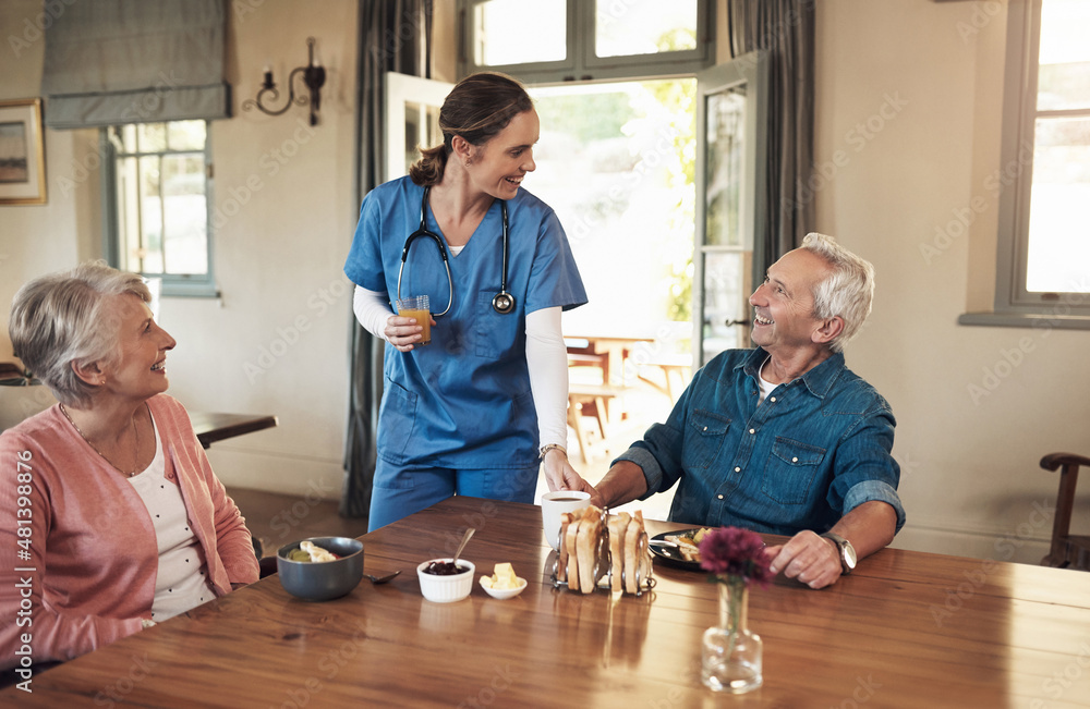 Canvas Prints Good morning to my favourite residents. Shot of a young nurse checking up on a senior couple during breakfast at a nursing home.