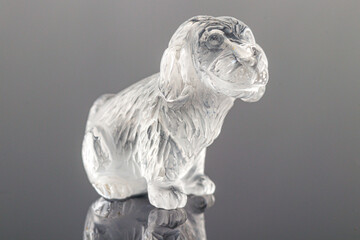 beautiful statuette of a dog from the mineral topaz on a gray background