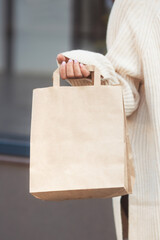 Young woman holding craft bag shopper after shopping. Copy space 