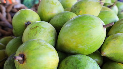 Canistel fruit fresh green. Close-up stack of raw fruits Canistel, Tiesa, Yellow sapote, Canistelsapote :Pouteria campechiana (Kunth) Baehni on panel. Selective focus.