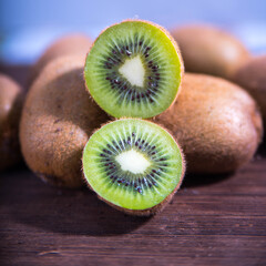 Kiwi halves on wooden background, macro photography, copy space