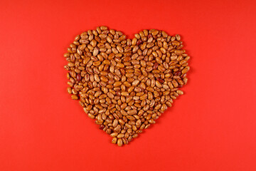 A pile of Dried Kidney Beans in the shape of a heart on the white background. Healthy food concept. love food, heart food, valentine\'s Day concept. Flat lay, copy space