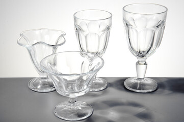 Set of four ice cream glasses of different hights and shapes, isolated