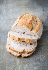 A homemade crusty loaf of bread on dark background