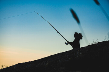 Fisherman on rocky shoreline