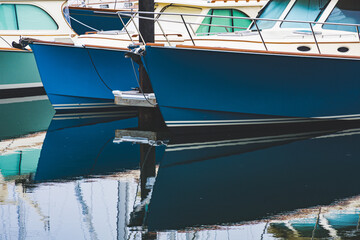 Closeup shot of small seaside harbor waterline with sail boats docked on Aquidneck Island, Rhode Island near Newport