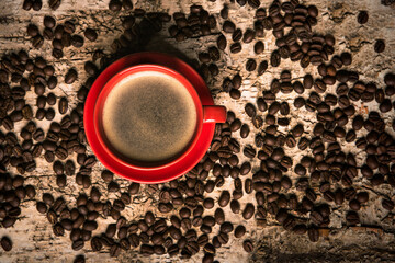 Coffee cup with beans on wood