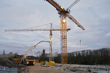 yellow concrete mixing truck and concrete pumping truck on a construction site Halle an der Saale