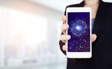 Neural networks and other concepts of modern technologies. Hand hold white smartphone with digital hologram Artificial intelligence sign on light blurred background.